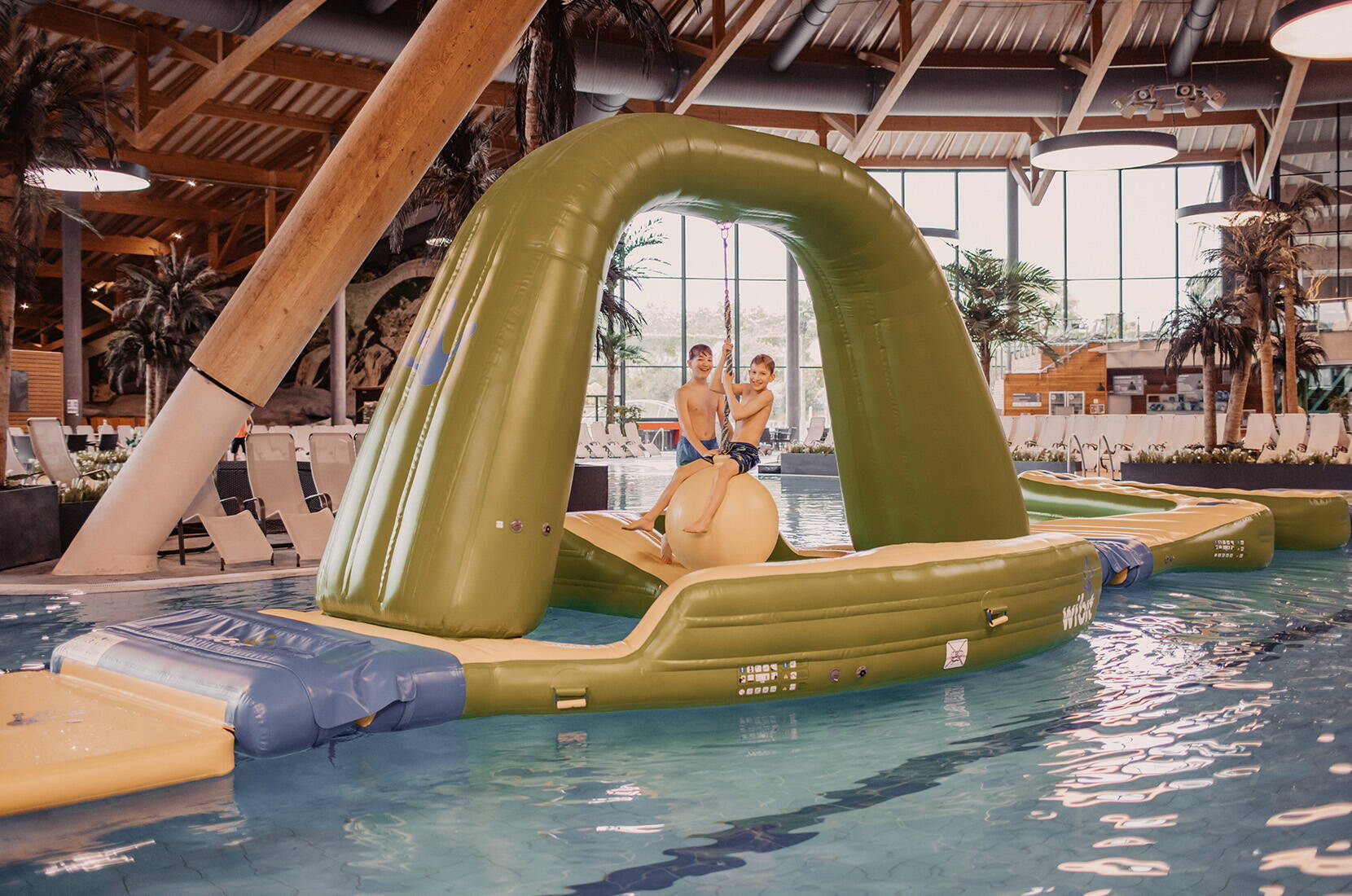  Bambini si divertono su una grande isola gonfiabile nella piscina interna.