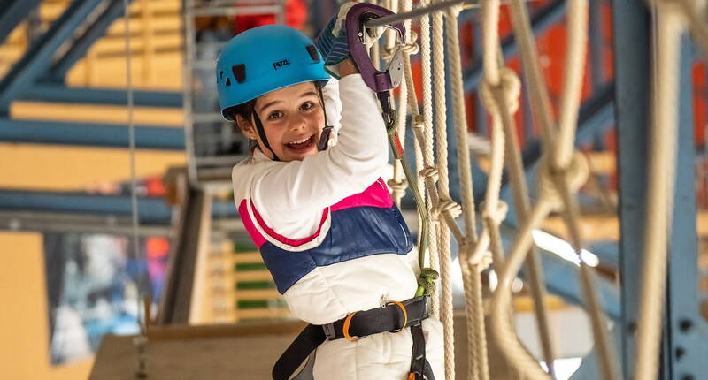 Excursion en famille au parc d'escalade à cordes indoor de Grindelwald. Sous le toit de la patinoire, petits et grands peuvent se balancer et grimper sur des éléments plus ou moins branlants et passionnants, et ce par tous les temps : sec et sans vent en hiver, frais en été!