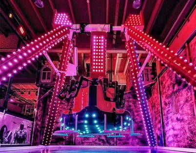 Un’attrazione luminosa in un funpark al coperto offre divertimento dinamico con luci LED colorate.